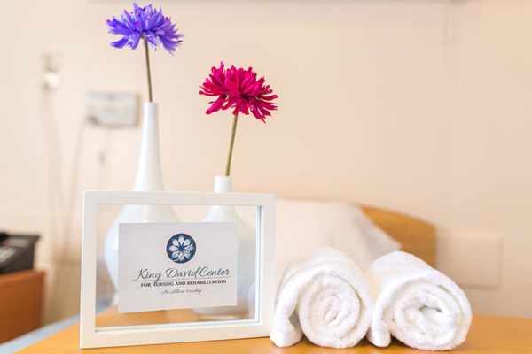 Flowers behind sign and towels